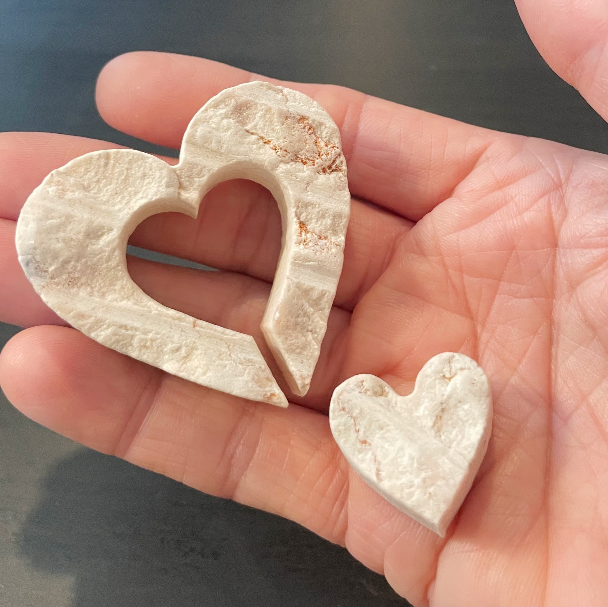 Hand holding Jerusalem stone hearts