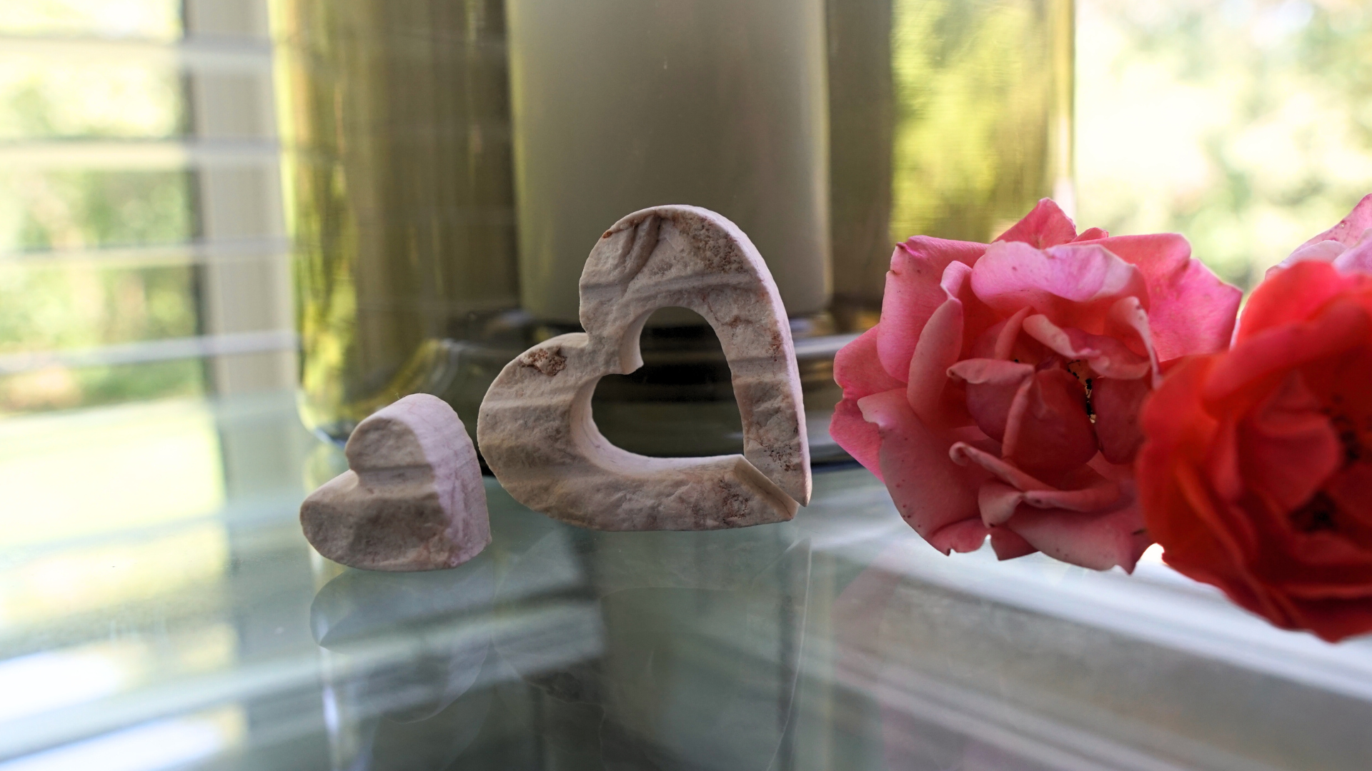 Nesting hearts made from Jerusalem Stone on table with flowers