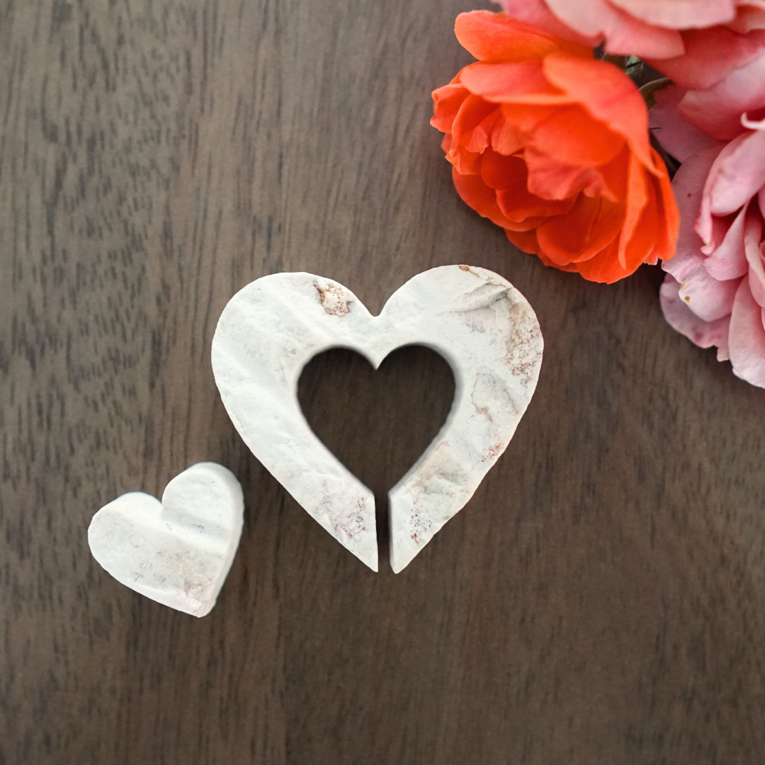 Nesting hearts made from Jerusalem Stone on table with flowers