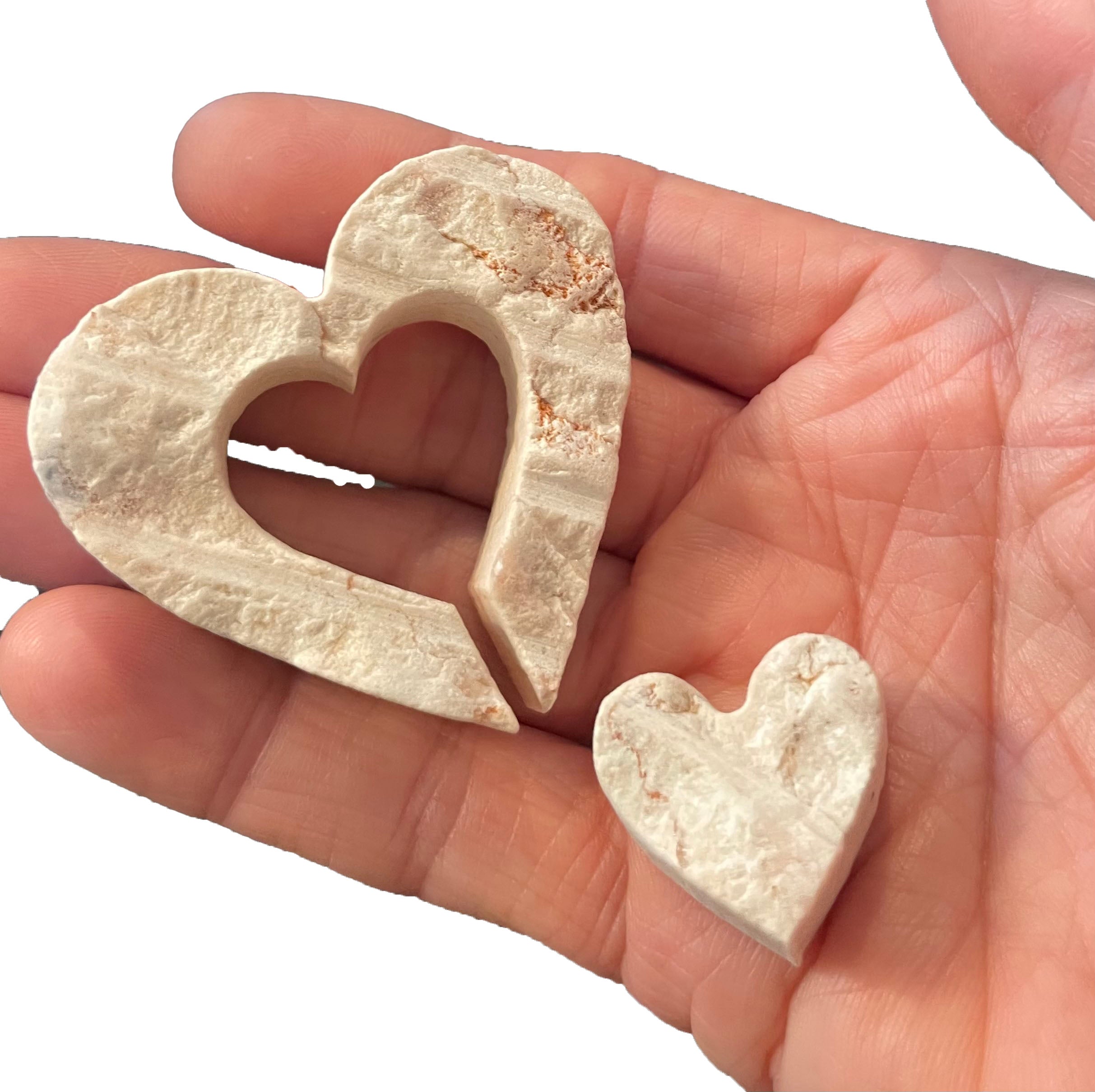 Person holding tow nesting hearts made from Jerusalem Stone