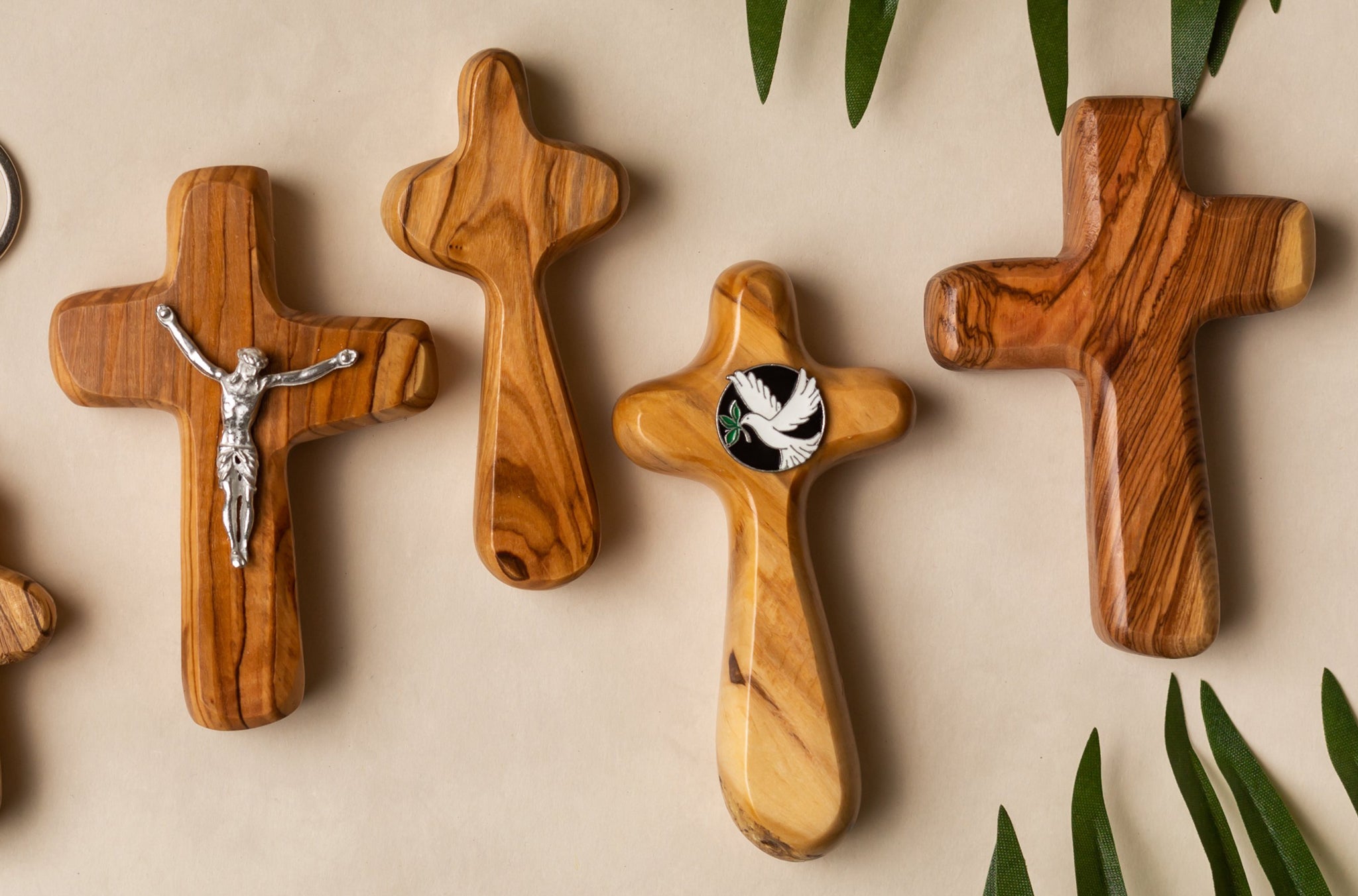 Four olive wood crosses with palm leaves
