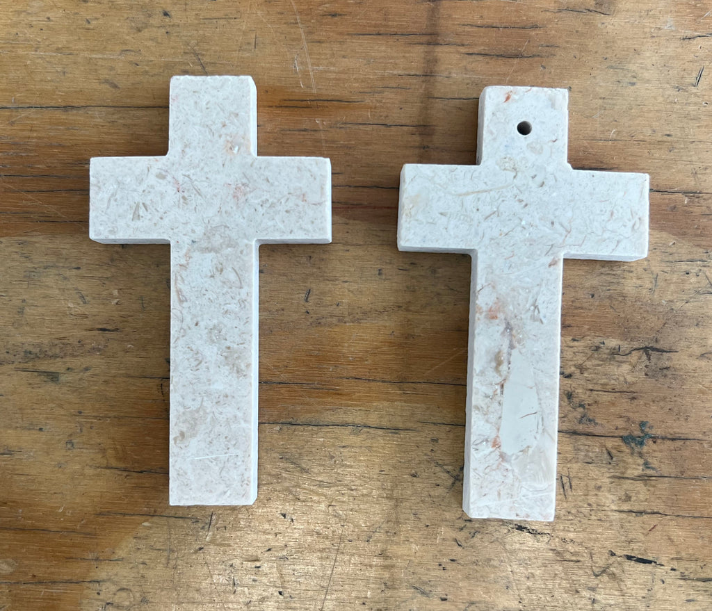 Two Jerusalem Stone crosses on wooden table